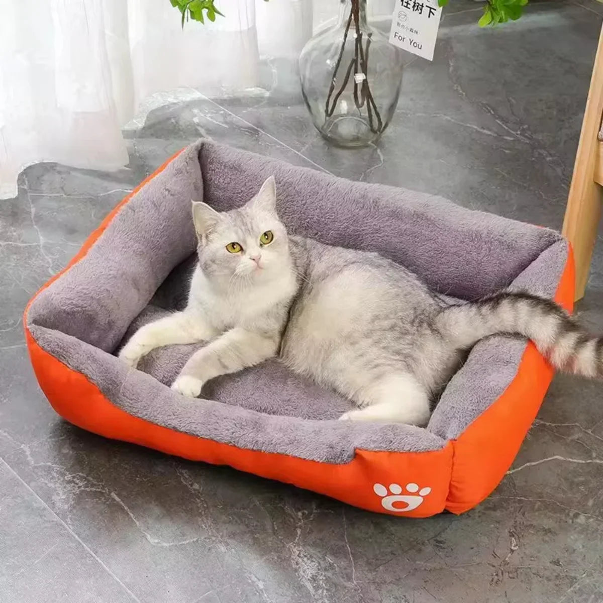 Breathable, lightweight, and washable cat bed in orange and gray, perfect for year-round comfort and style.