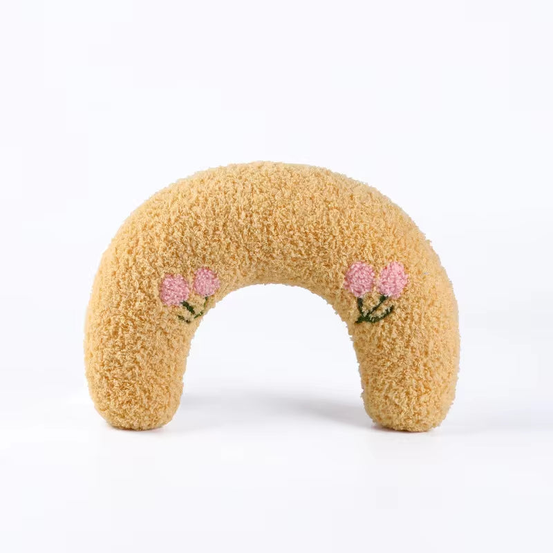 U-shaped pet pillow for cats and small dogs, soft and calming, in pastel yellow with floral details.
